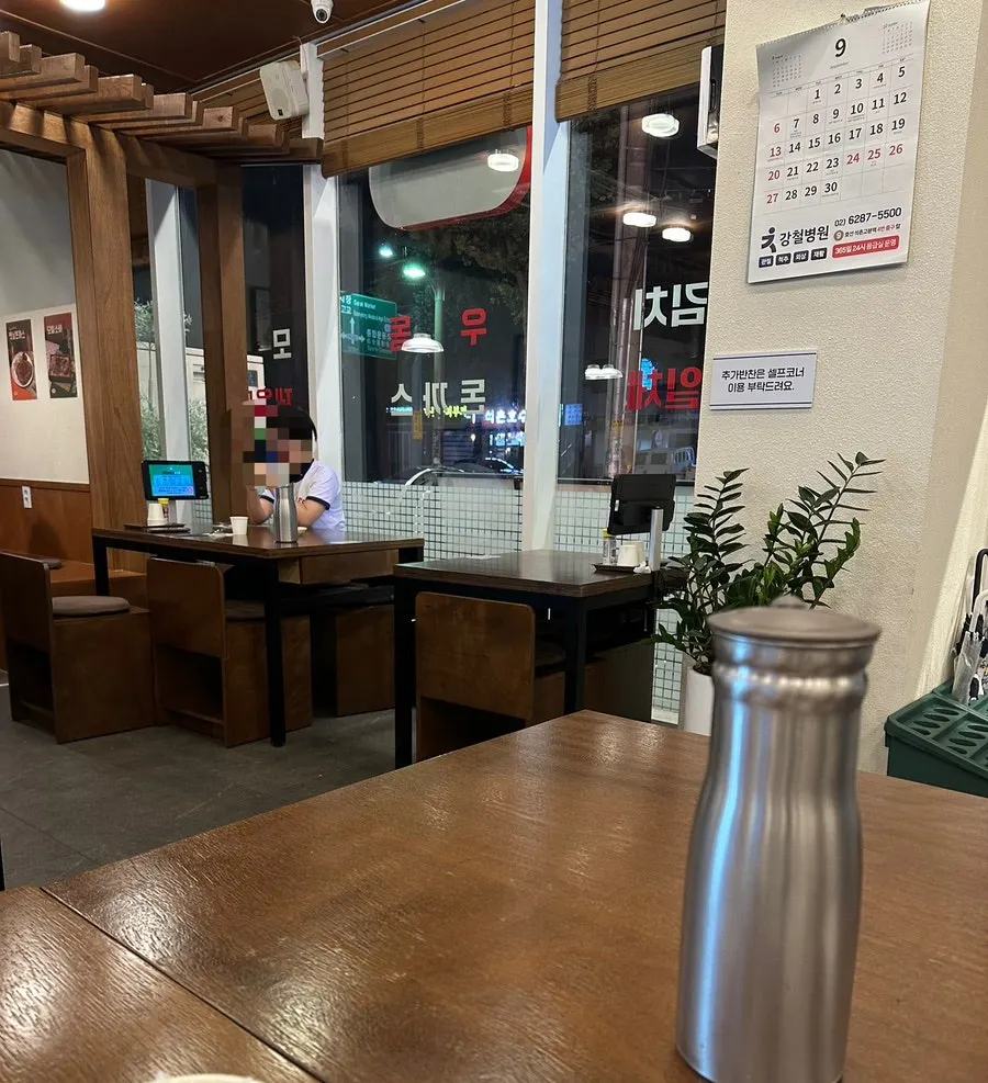 Interior of the 24-hour udon restaurant with several tables