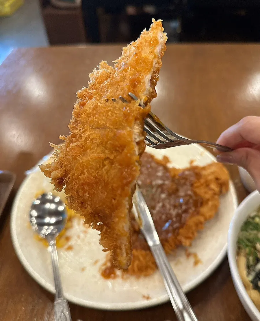 Cross-section of the pork cutlet showing crispy breading
