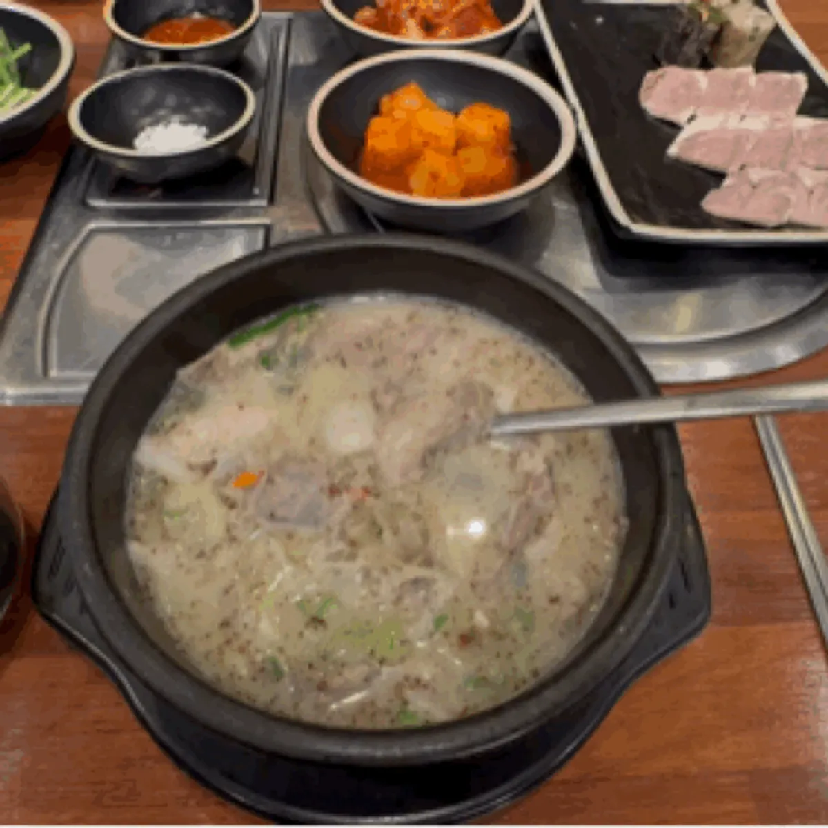 A bowl of sundae gukbap loaded with chives