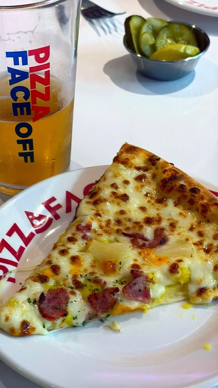 A slice of pizza with thin base and fluffy crust