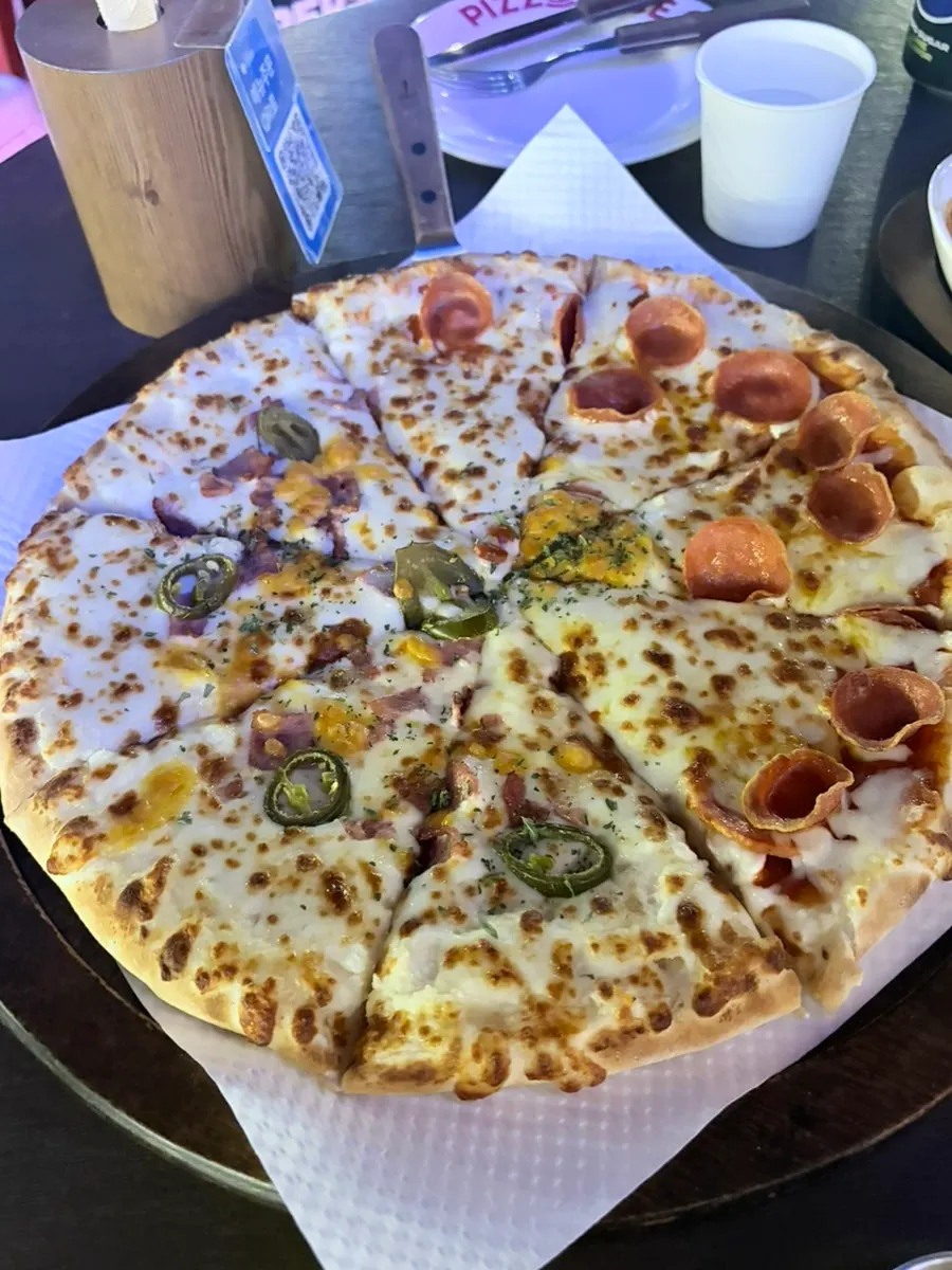 The half-and-half pizza served on the table