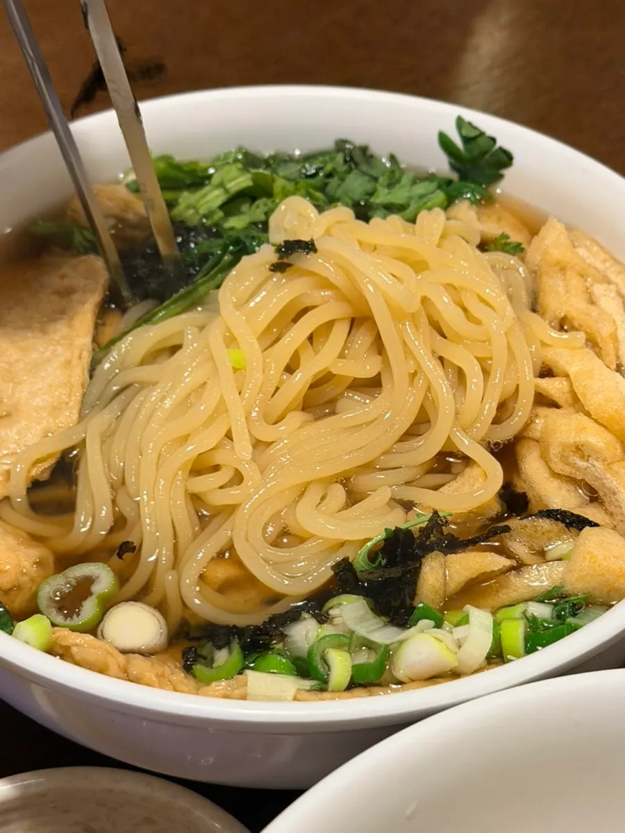 A bowl of fish cake udon full of broth