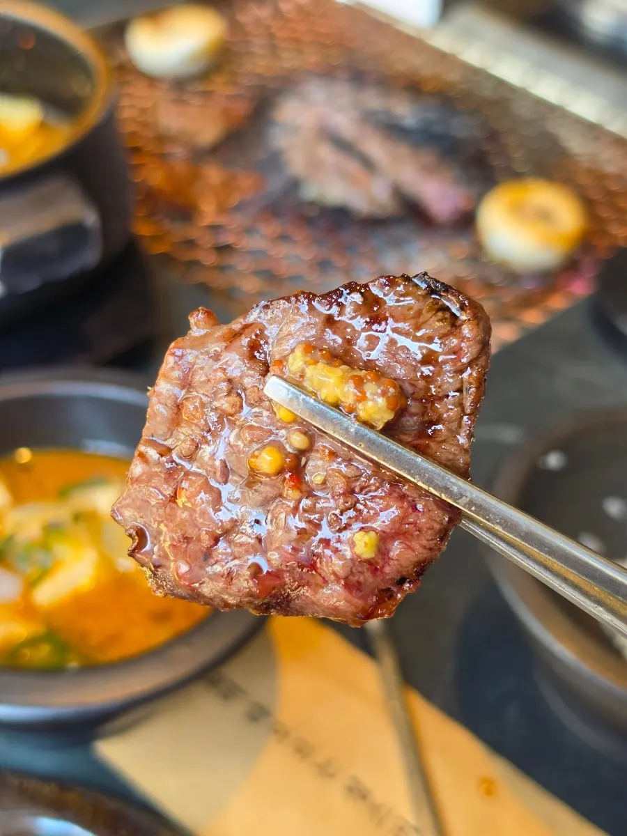 A bite of grilled beef with vegetables