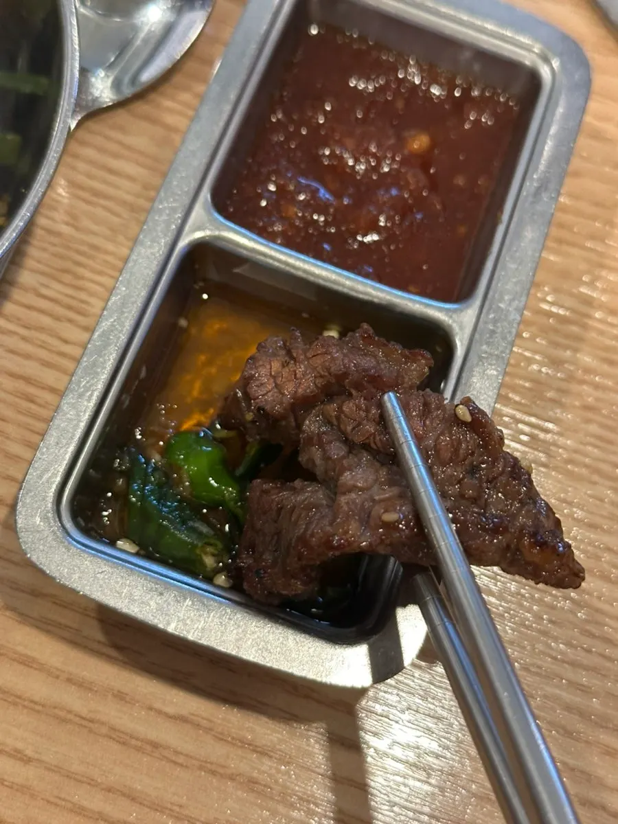 Galbisal being dipped into sauce