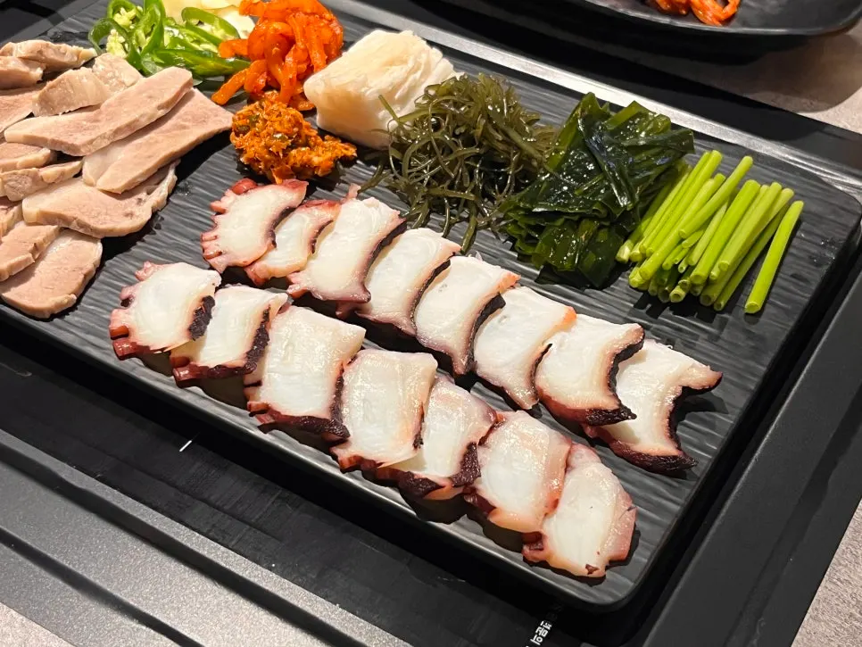 Table spread of octopus dishes with side dishes
