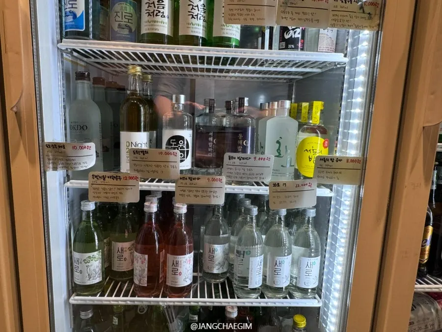 Choosing a drink at Imokase Hongsi to match the anju