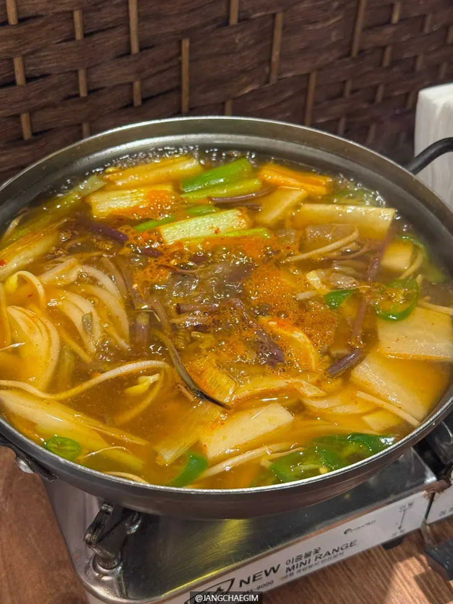 Spicy beef radish soup simmering at the table