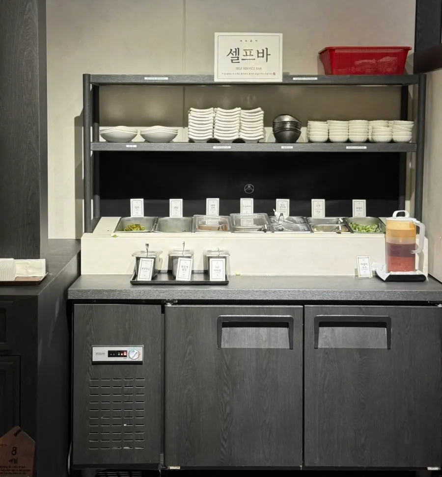 Self-serve bar with dishes and sauces on display