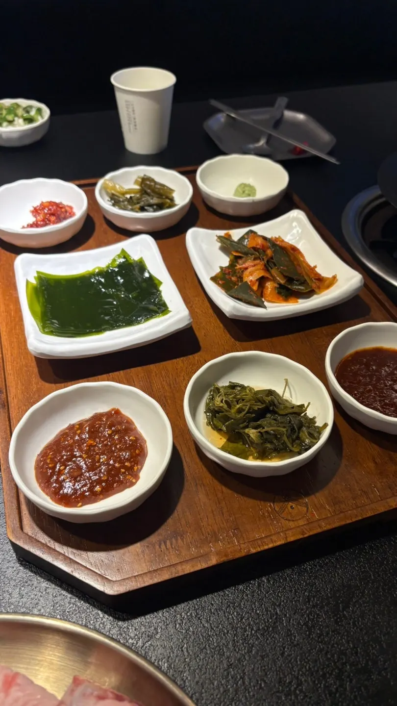 Table setting with kelp, scallion kimchi, and other side dishes