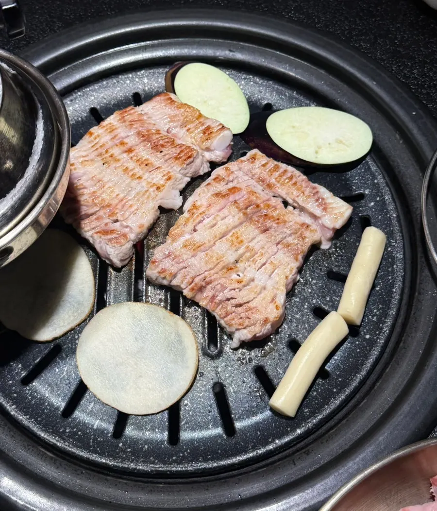 Thick raw ribs on the grill