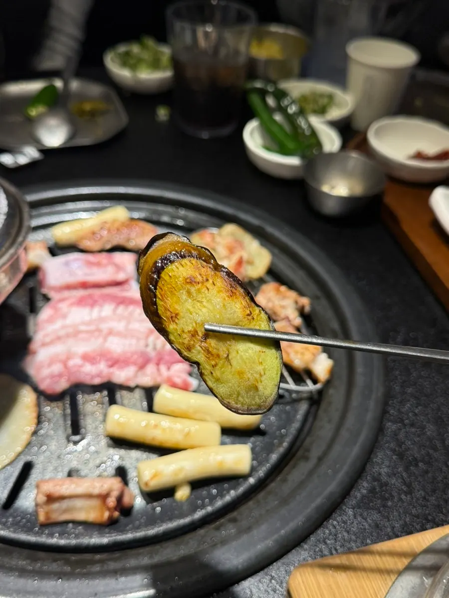 Grilled eggplant picked up with chopsticks