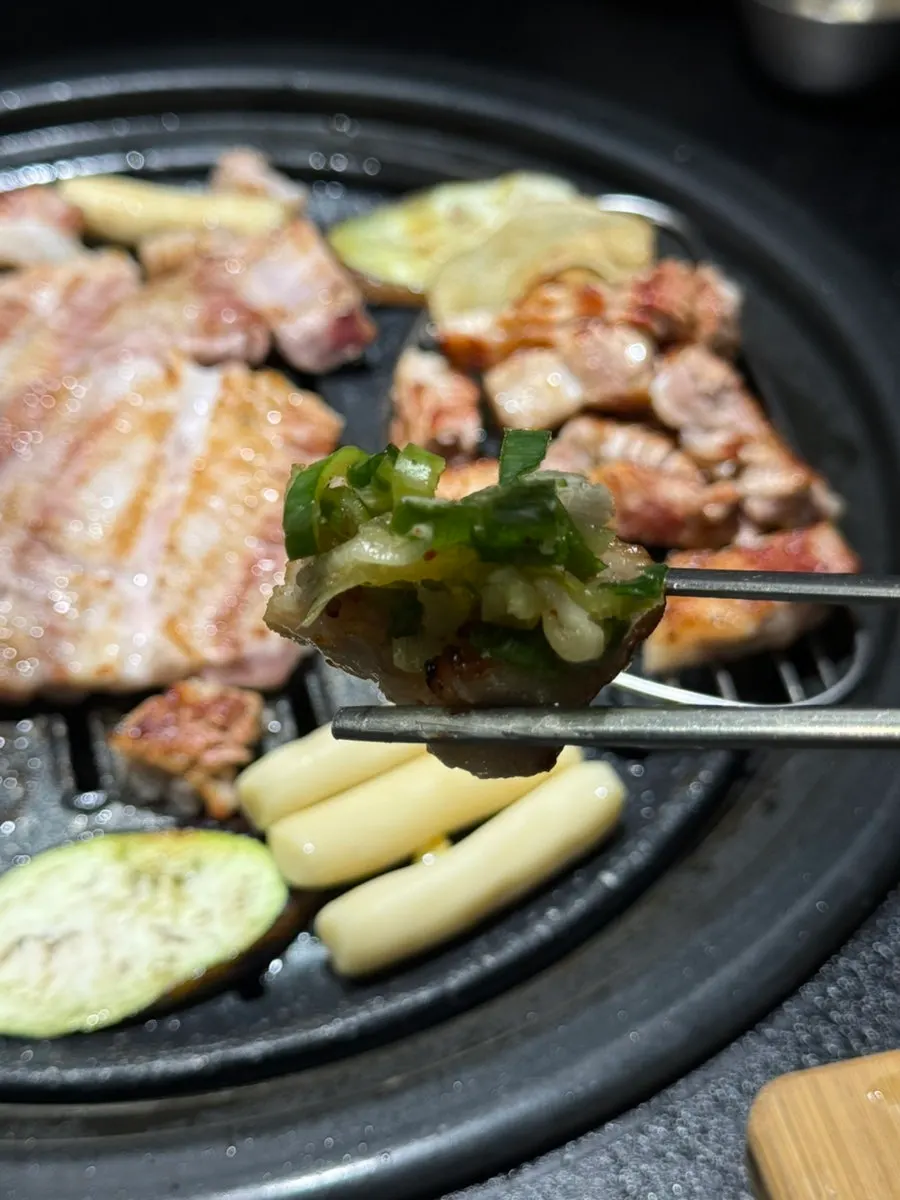 A piece of ribs topped with scallion sauce