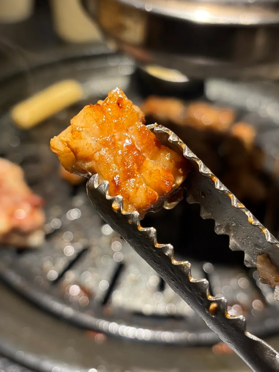 A piece of heukdon galbi with slightly charred marinade