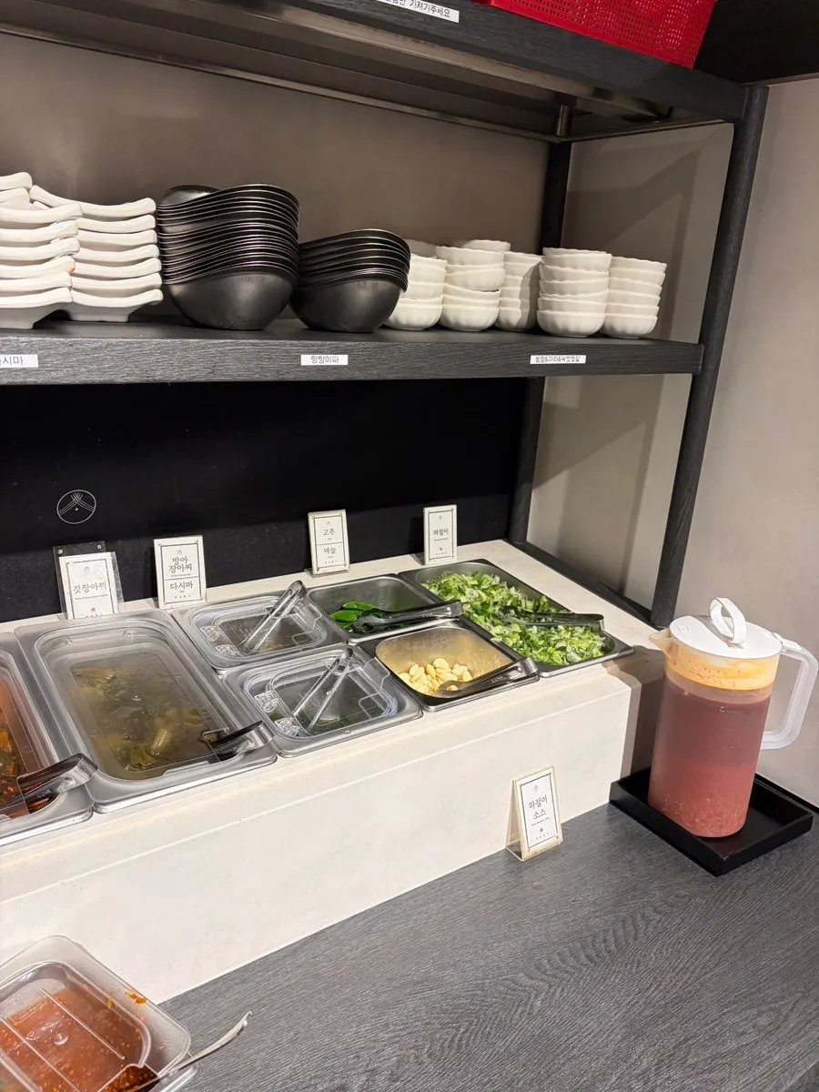 Scallion kimchi and pickled side dishes at the self-serve bar