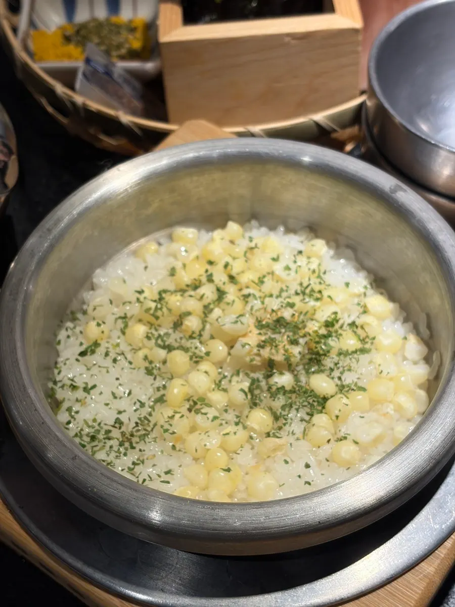 Seokok Galbi sagye sotbap topped with corn