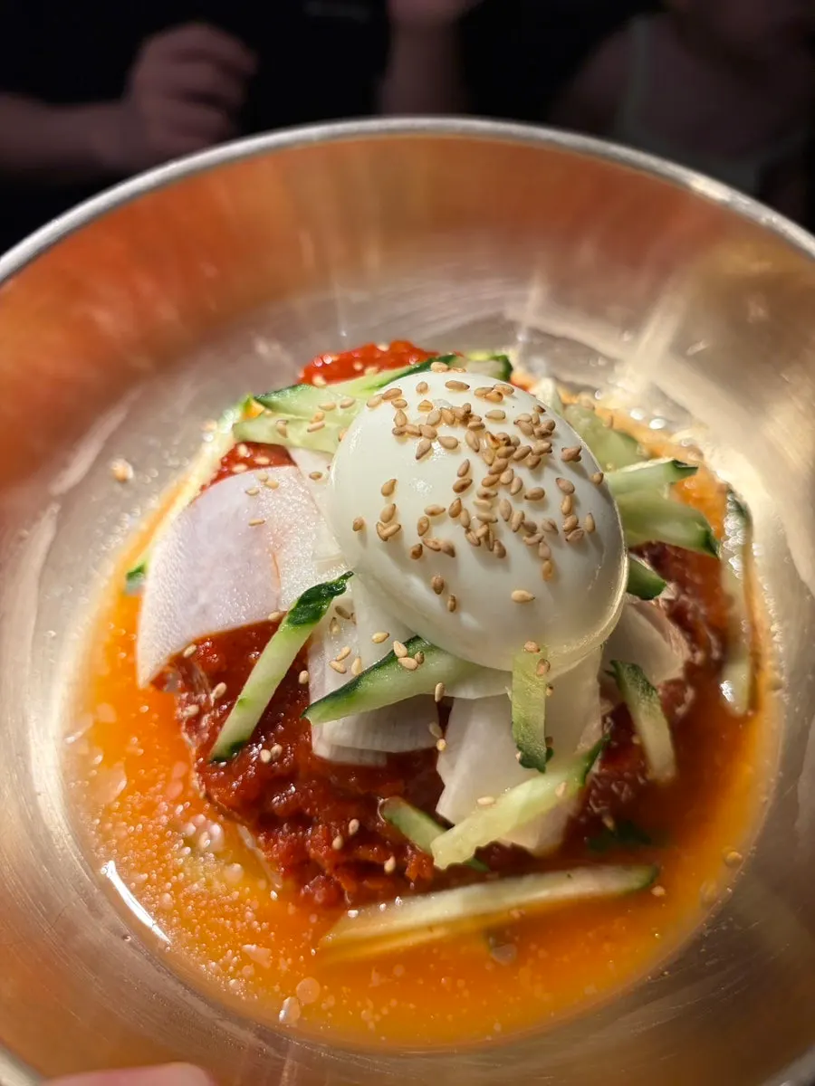 Bibim milmyeon topped with cucumber and egg