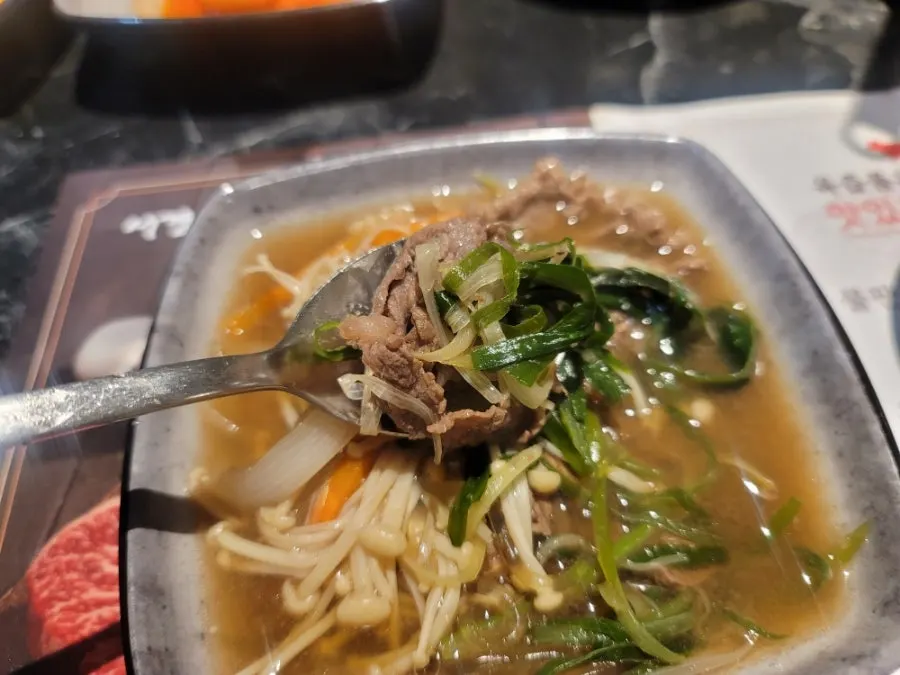 Hanwoo beef and vegetables scooped from the hotpot