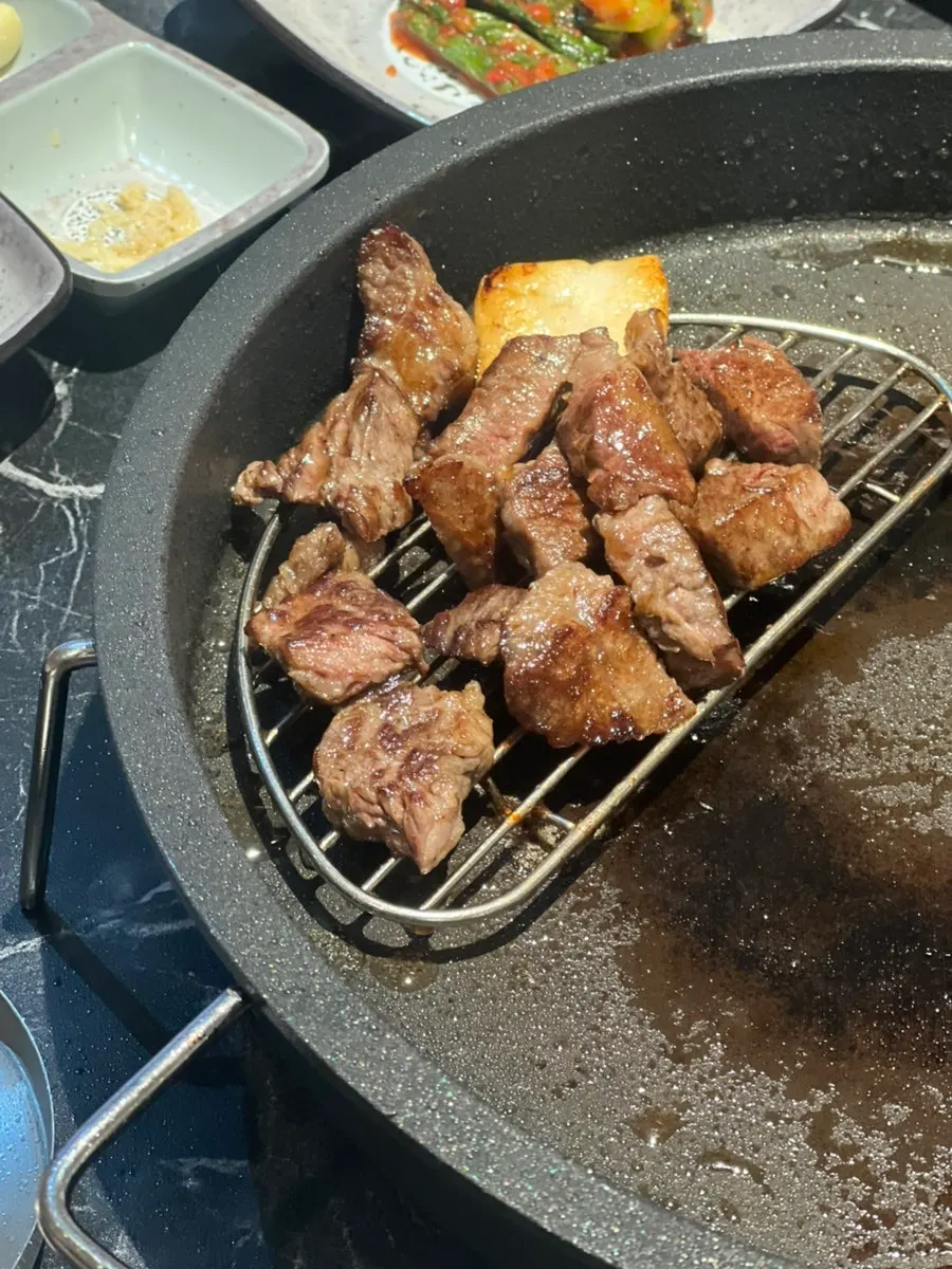 A cooked piece of hanwoo beef with side dishes