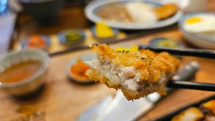 A bite of pork cutlet with curry