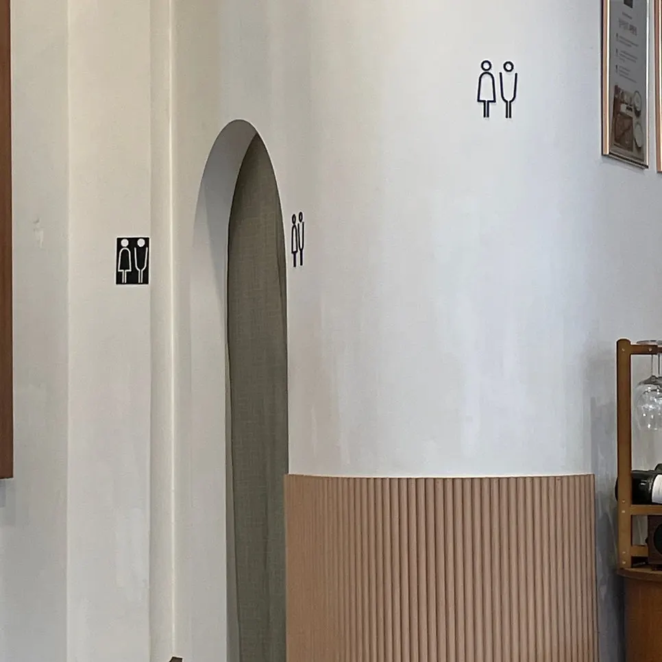 Entrance to the gender-neutral restroom at the back of the hall