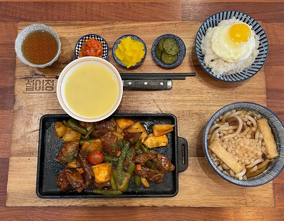 Chapsteak set spread served with udon and side dishes