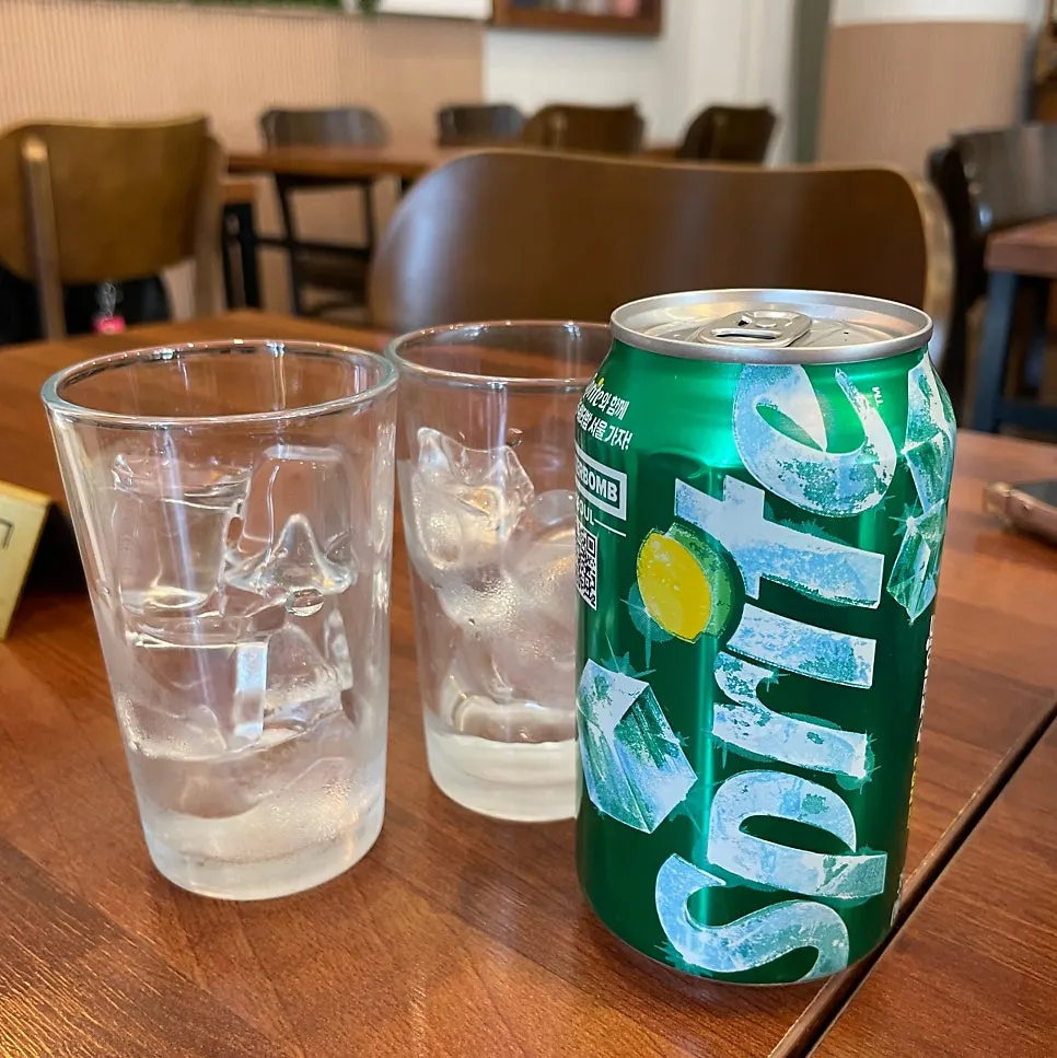 Two ice-filled glasses served with a soda