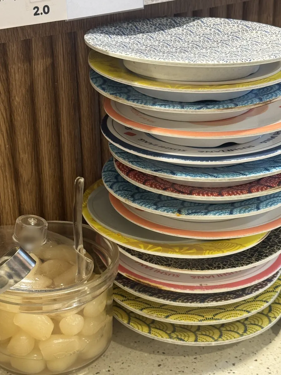 Sushi plates set alongside the sake