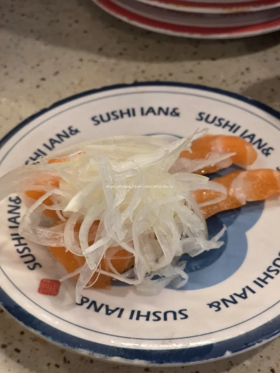Salmon onion sushi topped with onion