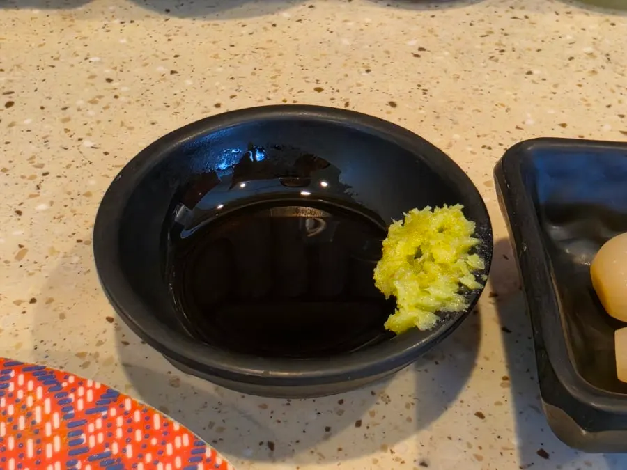 Close-up of sushi plates passing on the belt