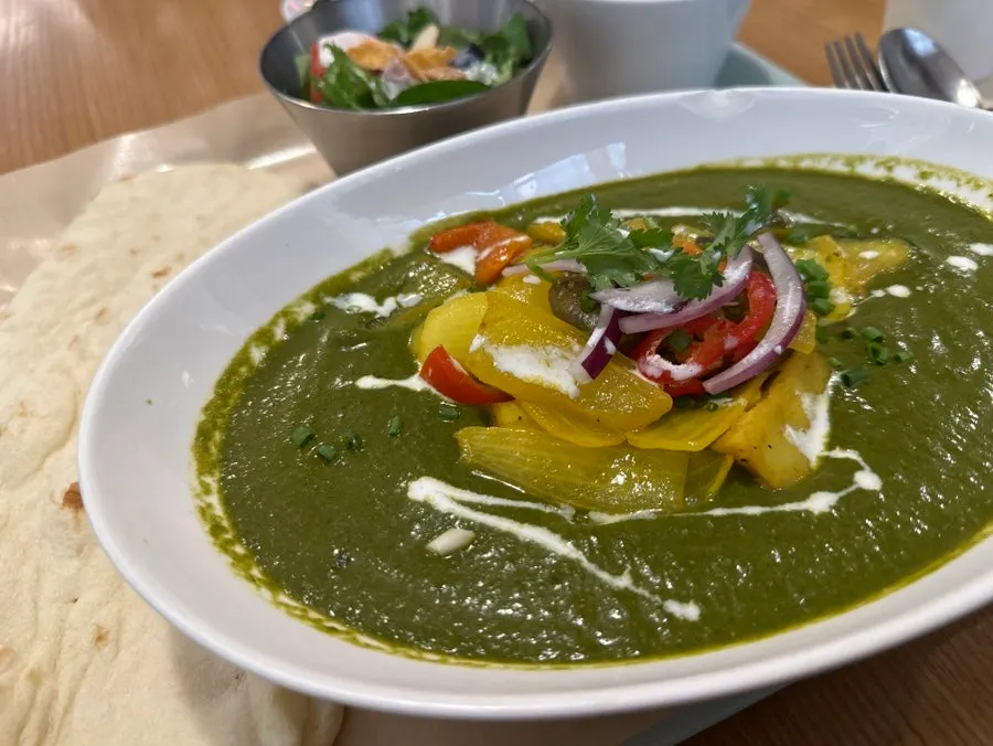擺上烤蔬菜配料的菠菜咖哩套餐