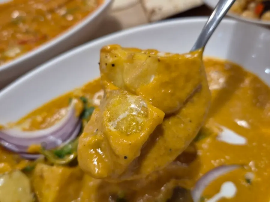 A full spread with curry and naan