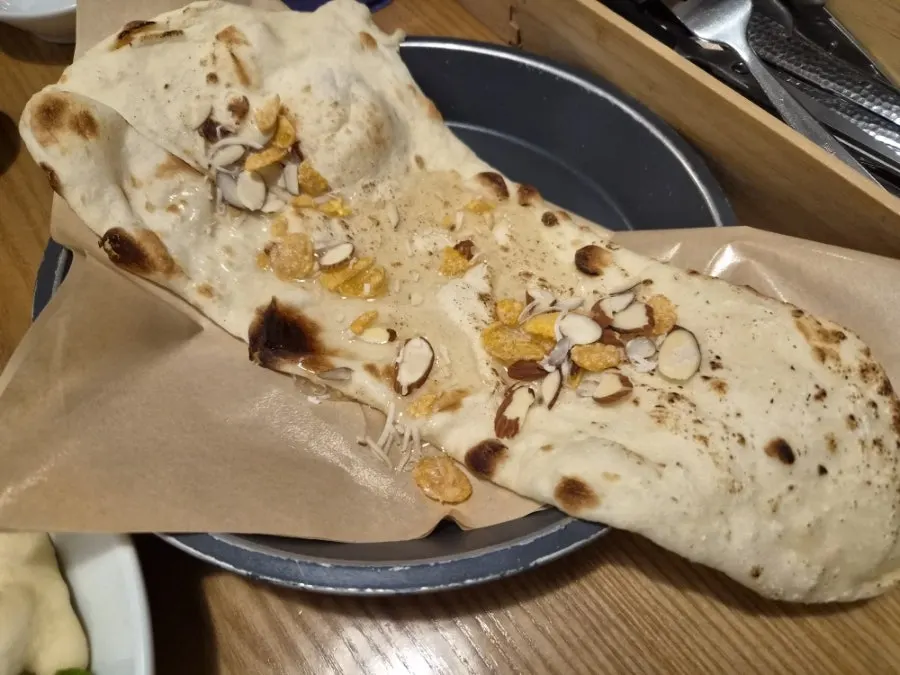 Chewy naan dipped in curry
