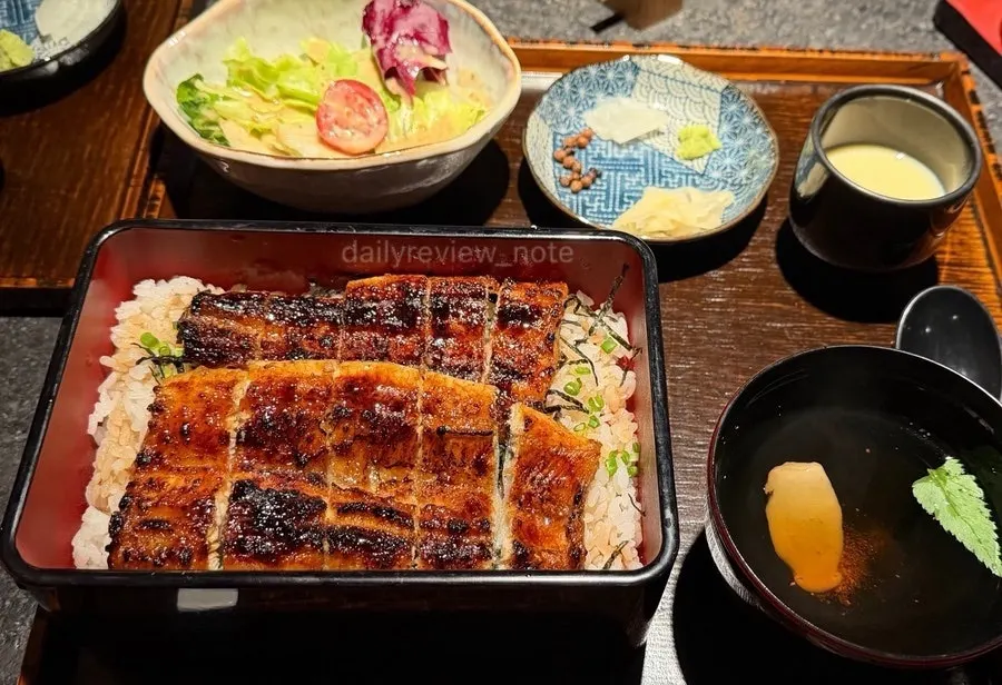 Full table spread with Manmok's eel rice bowl