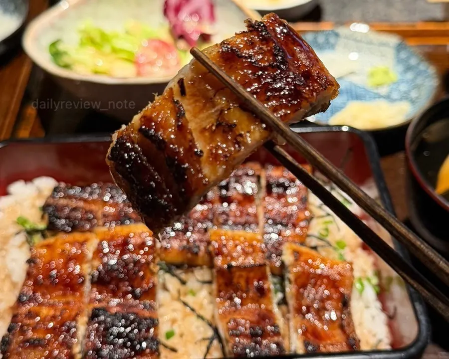 Whole eel piled so high the rice is hidden