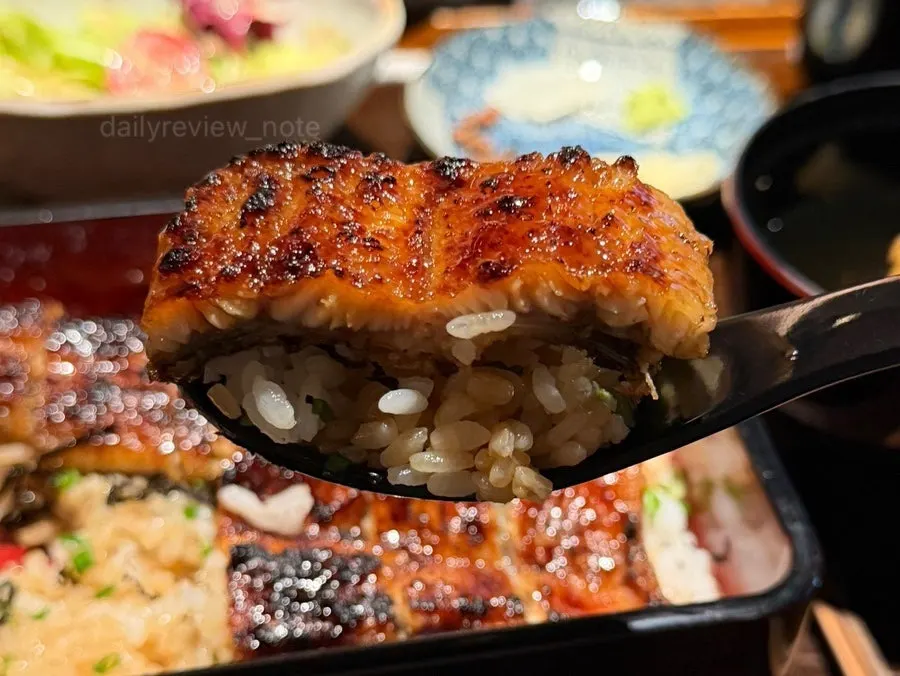 A spoonful of rice topped with eel
