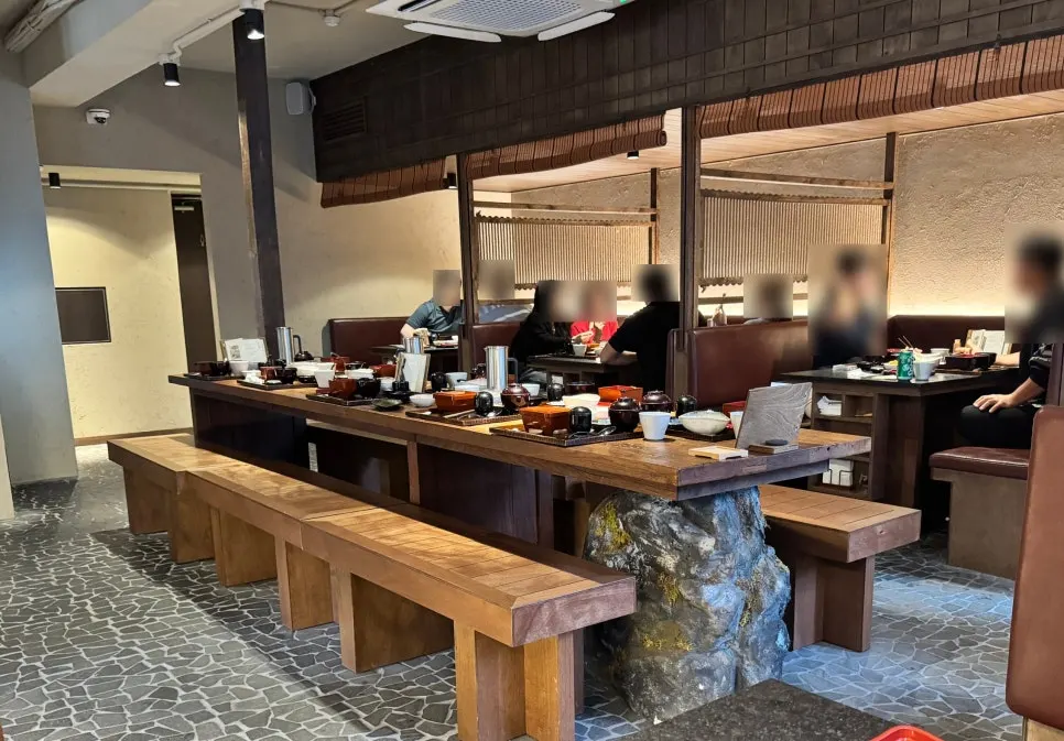 Manmok's dining hall seating under soft lighting