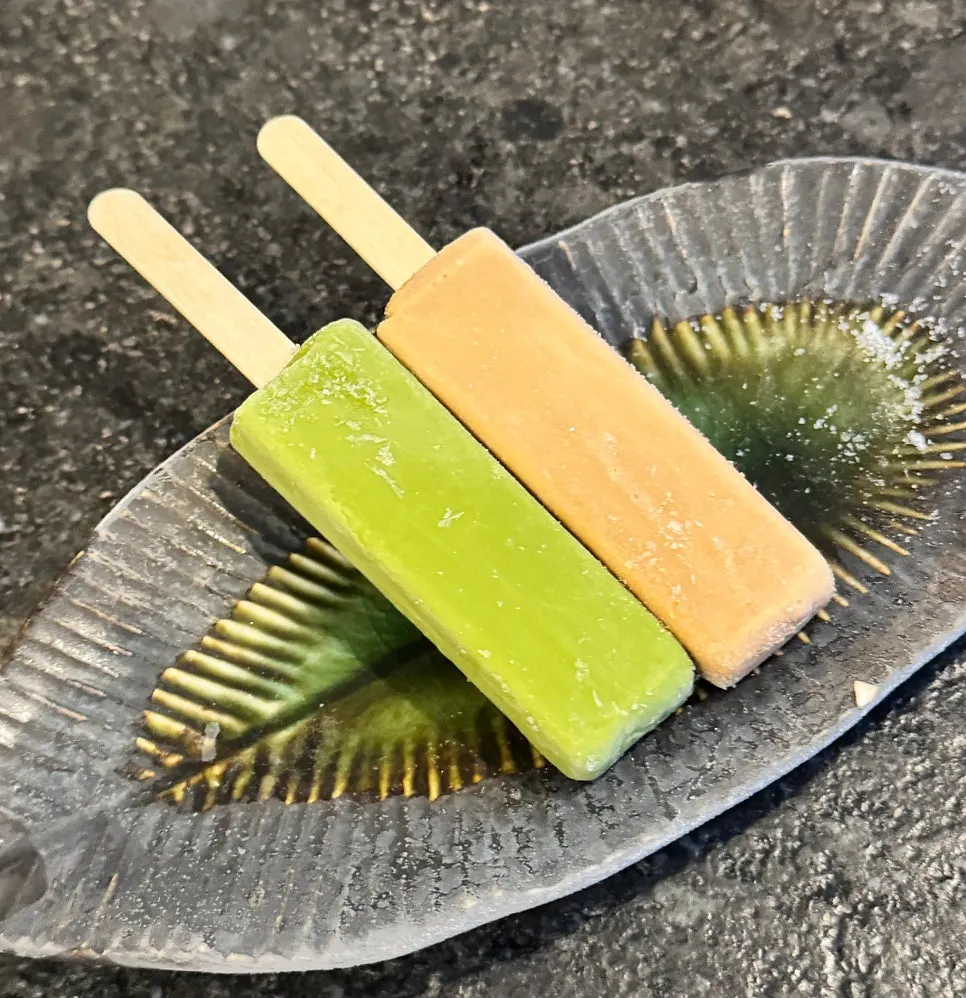 A piece of tender eel lifted with chopsticks