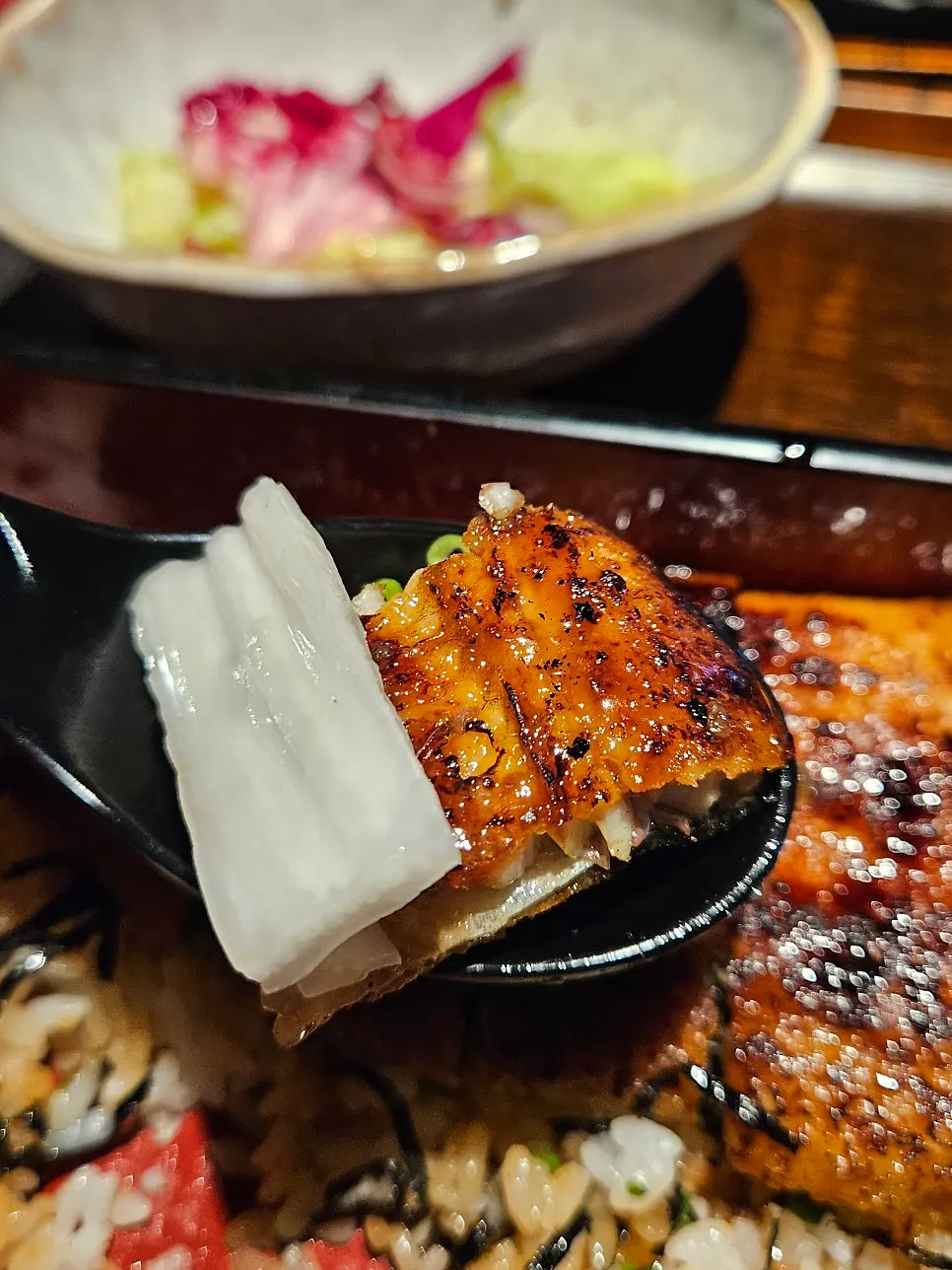 Eel rice bowl served with radish salad