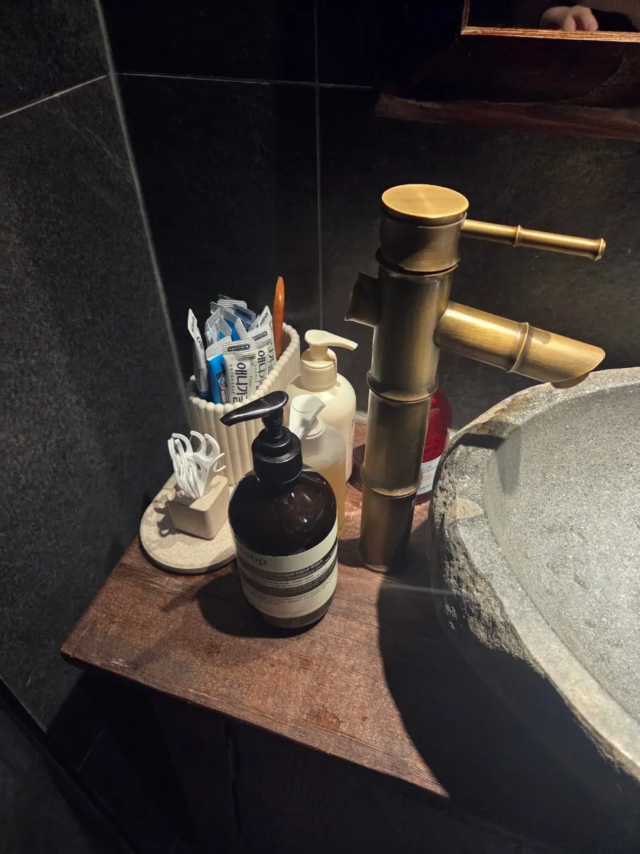 Restroom stocked with floss and other amenities