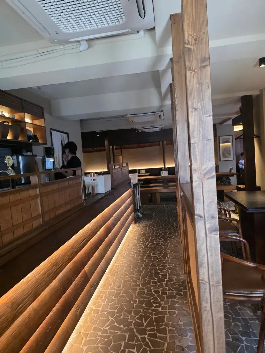 Large wooden table and chair seating in the center of the restaurant