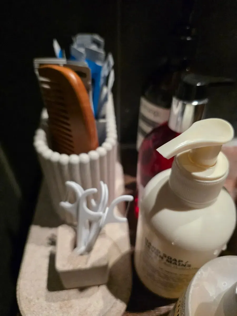 Stone-like sink and amenities in the restroom