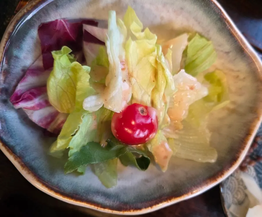 Side salad topped with cherry tomatoes