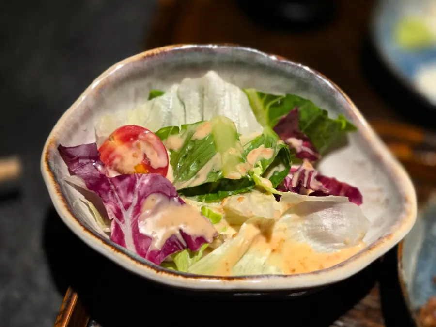 Salad topped with sesame dressing