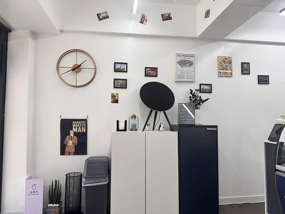 Wall with black-and-white photo frames and miniature decor