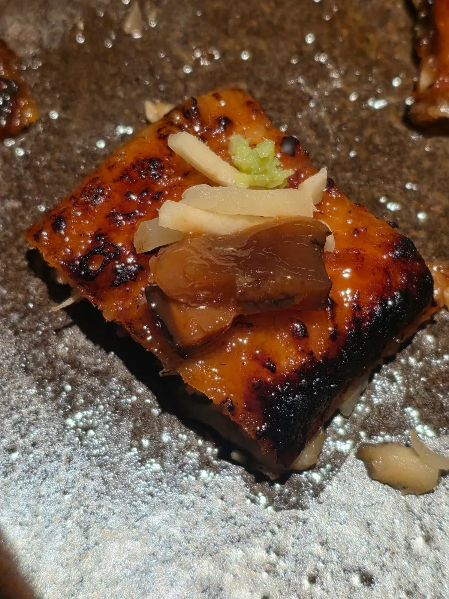 Seasoned eel topped with wasabi and ginger