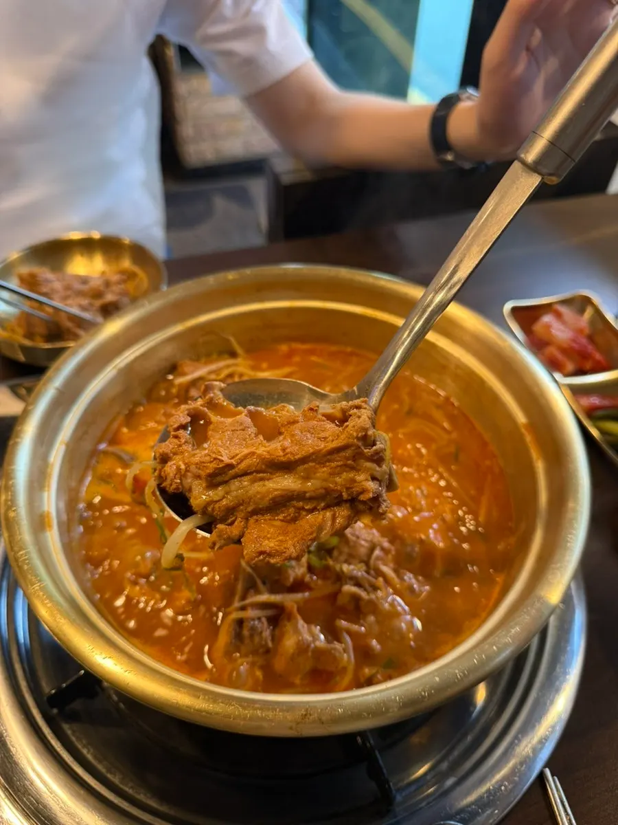 Gamjatang meat and broth portioned into a side plate