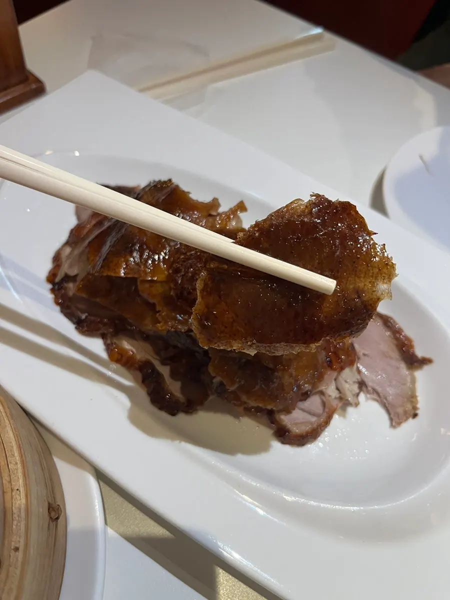 Peking duck wrap in a wheat pancake with scallion and cucumber
