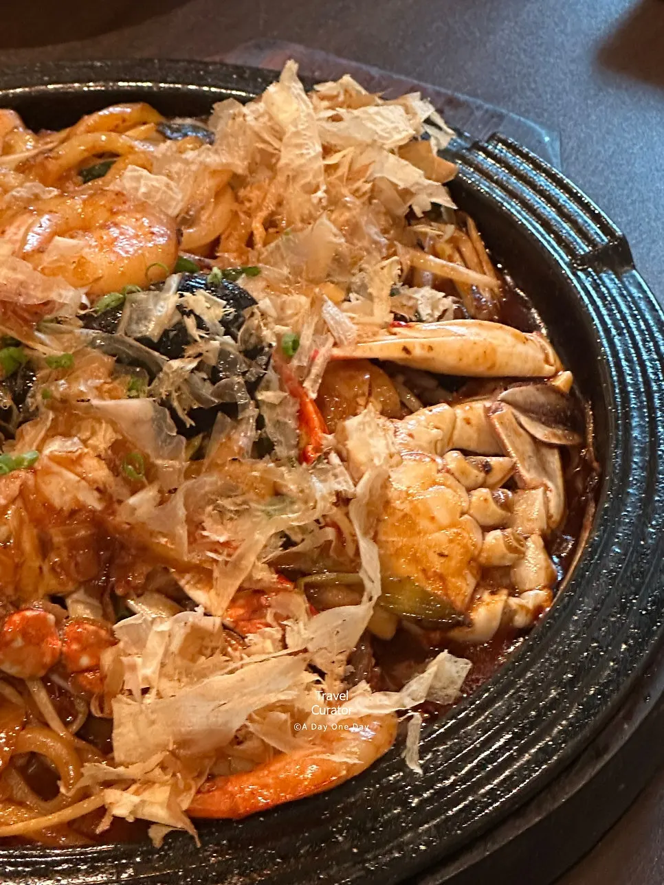 Lifting a bite of seafood yakiudon noodles