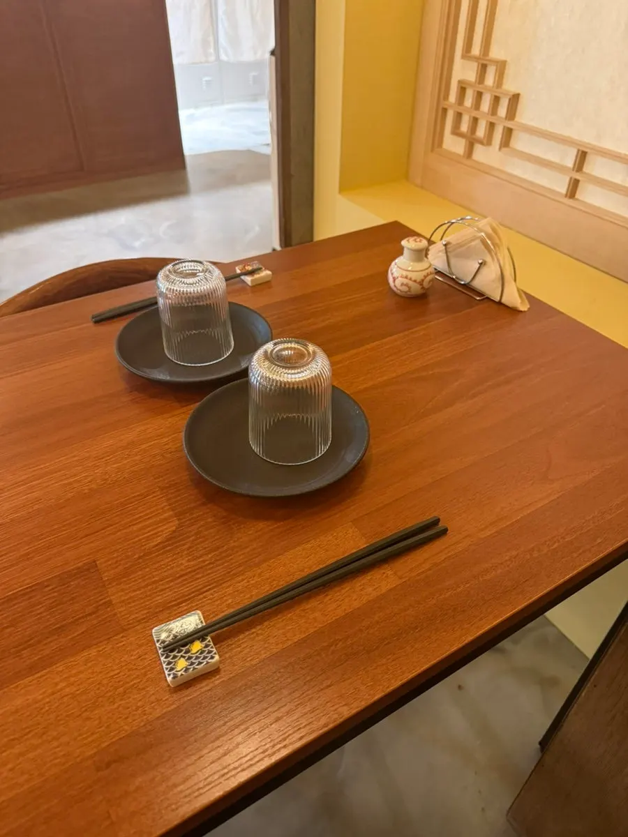 Two tables pushed together to seat three people