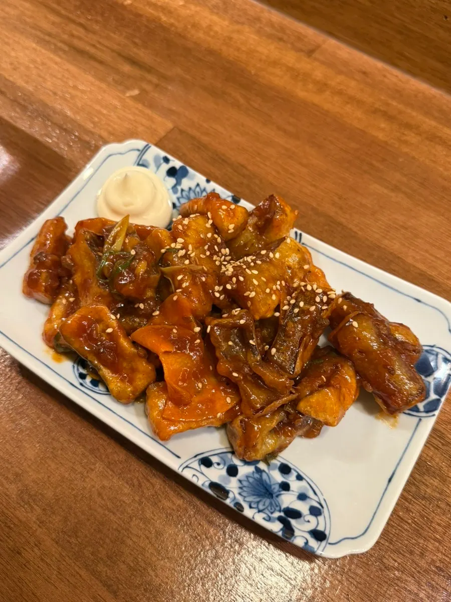 Close-up of sabamiso-ni topped with scallions